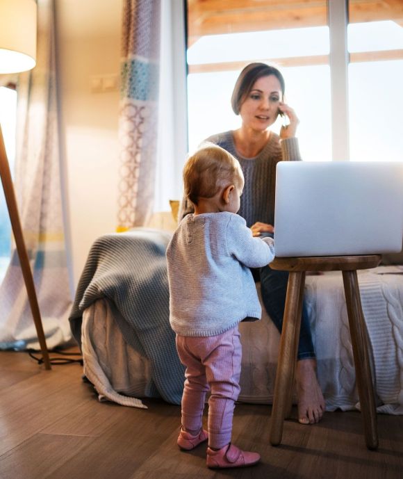 Frau am Laptop mit Kind