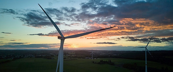 Windräder in einer Landschaft bei Sonnenuntergang