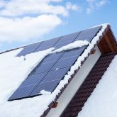 solar panels on the roof covered with snow in winter solar panels on the roof covered with snow in winter