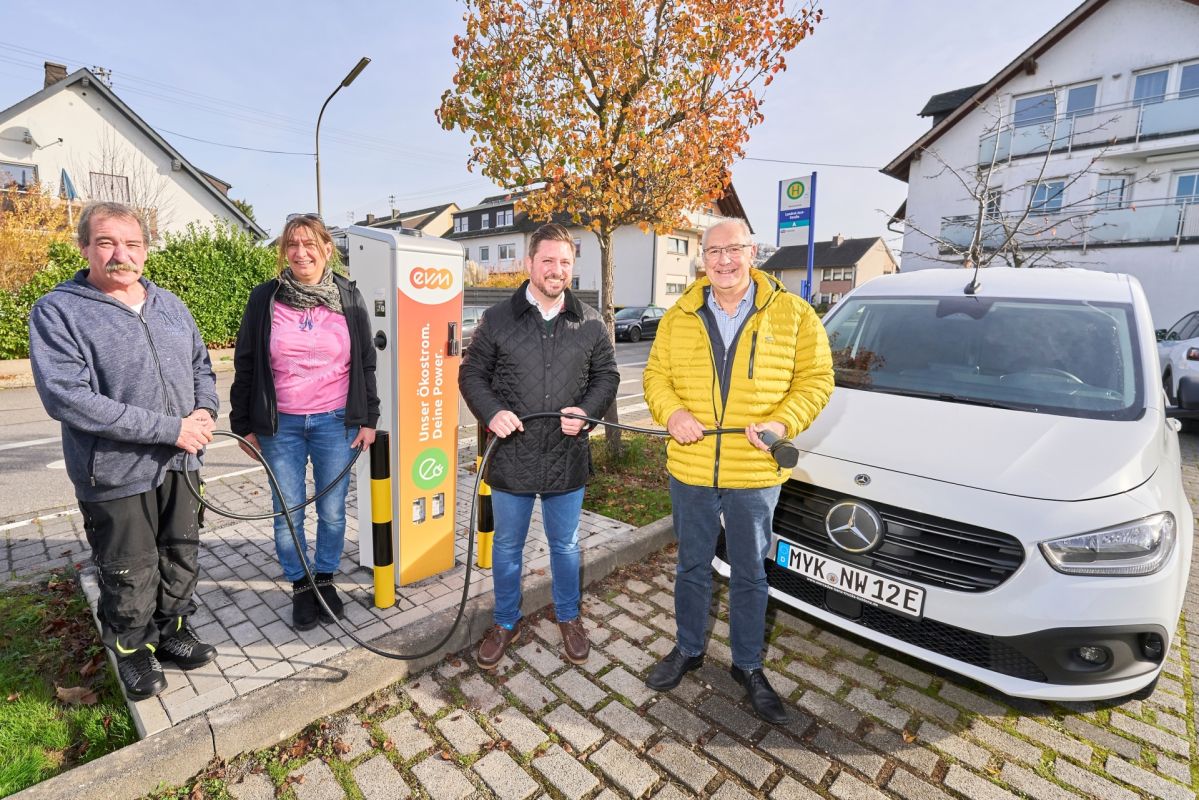 Vier Personen stehen um die Ladesäule der evm auf dem Niederwerth bei der Eröffnung