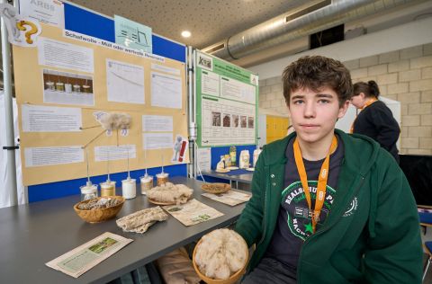 Jugend forscht 2026 - Regionalwettbewerb Koblenz Am Präsentationsstand liegen verschiedene Proben und Produkte aus Schafswolle ausgestellt; im Hintergrund zeigt ein Poster Versuchsergebnisse zu den Dämmeigenschaften des Naturmaterials.