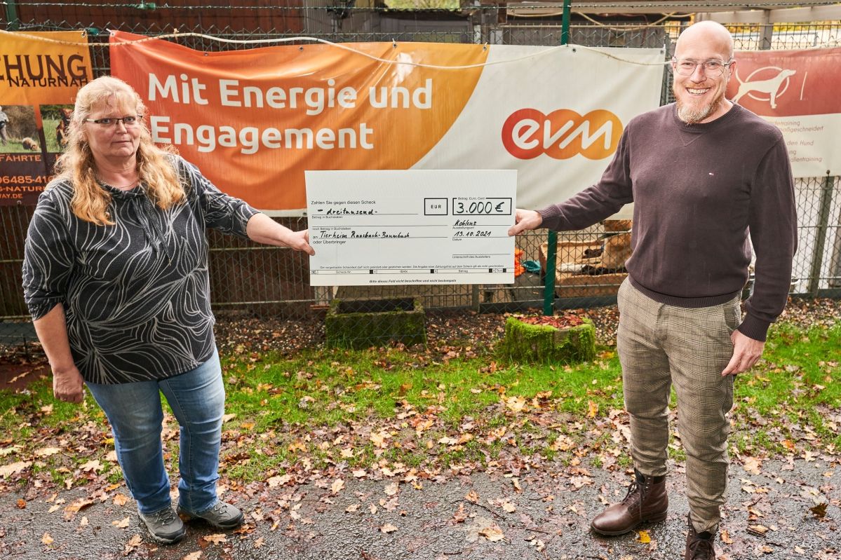 Christian Schröder überreicht einen Scheck an die Leiterin des Tierheims